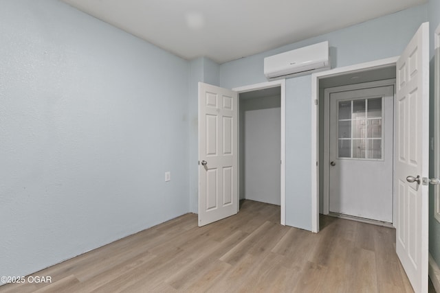 119 Jared Blvd, Webb City, MO 64870 - unfurnished bedroom with a wall mounted AC and light wood-style flooring