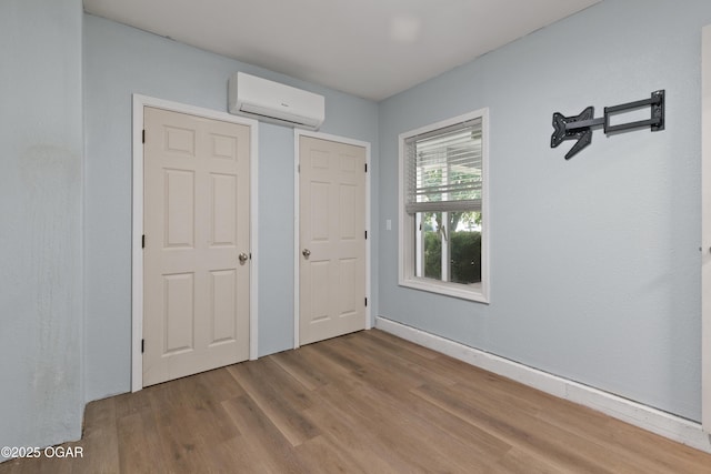 119 Jared Blvd, Webb City, MO 64870 - unfurnished bedroom with an AC wall unit and wood finished floors