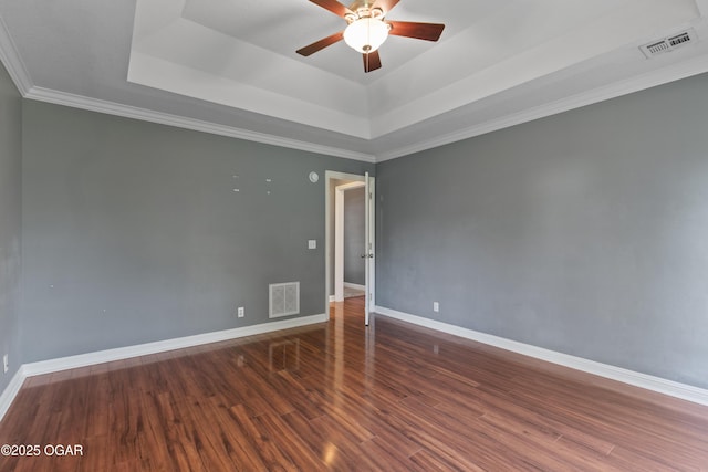 119 Jared Blvd, Webb City, MO 64870 - spare room featuring a tray ceiling, ceiling fan, wood finished floors, and ornamental molding
