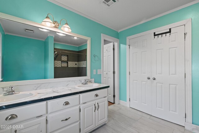 119 Jared Blvd, Webb City, MO 64870 - bathroom featuring ornamental molding, double vanity, a tile shower, and a closet