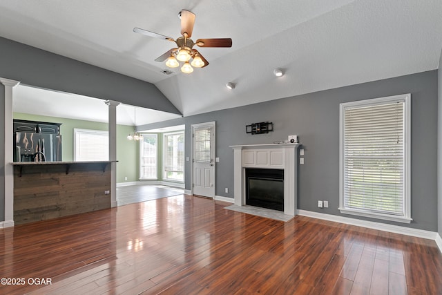 119 Jared Blvd, Webb City, MO 64870 - unfurnished living room with lofted ceiling, a fireplace with flush hearth, wood-type flooring, ceiling fan, and decorative columns