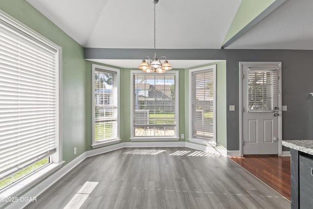 119 Jared Blvd, Webb City, MO 64870 - unfurnished dining area with lofted ceiling, a chandelier, wood finished floors, and healthy amount of natural light