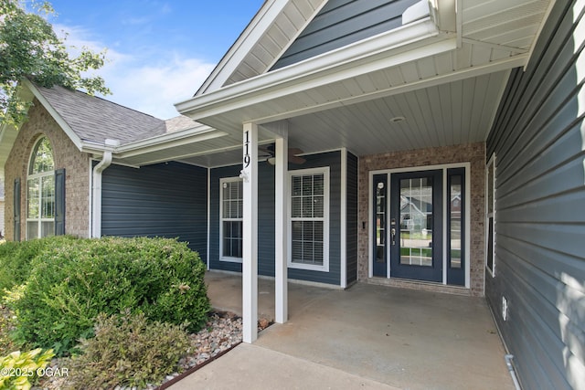 119 Jared Blvd, Webb City, MO 64870 - doorway to property featuring a shingled roof and brick siding