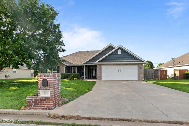 119 Jared Blvd, Webb City, MO 64870 - single story home with brick siding, an attached garage, and driveway