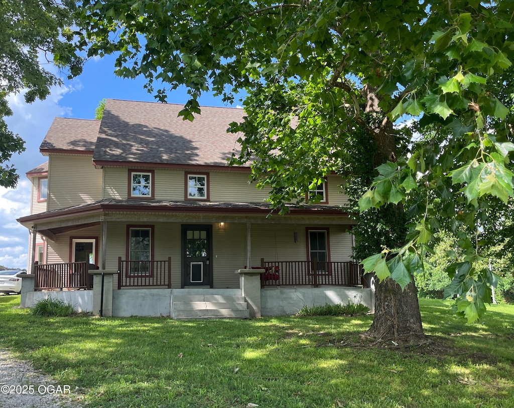 1631 County Road 120, Carthage, MO 64836 - view of front facade featuring a front lawn, a porch, and roof with shingles