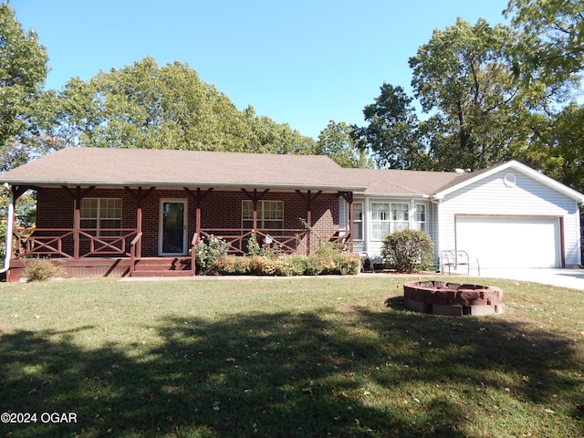 3065 Coyote Dr, Joplin, MO 64804 - ranch-style house with a garage, covered porch, a front yard, and brick siding