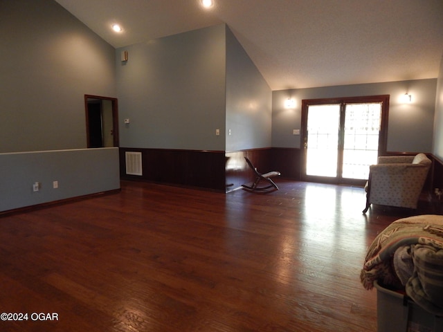 3065 Coyote Dr, Joplin, MO 64804 - living area featuring wood finished floors, high vaulted ceiling, and wainscoting