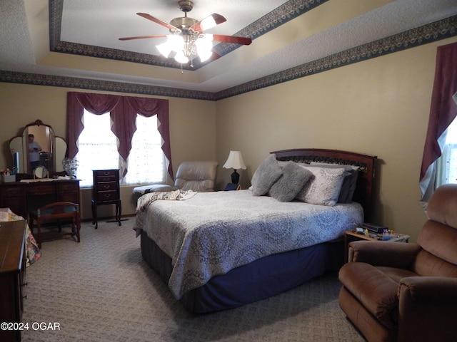 3065 Coyote Dr, Joplin, MO 64804 - bedroom with a raised ceiling, carpet floors, and a ceiling fan