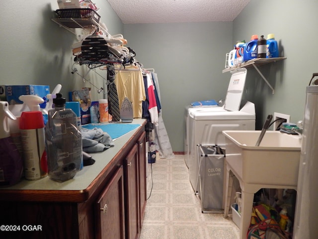 3065 Coyote Dr, Joplin, MO 64804 - laundry room featuring washer and dryer, cabinet space, light flooring, and a textured ceiling