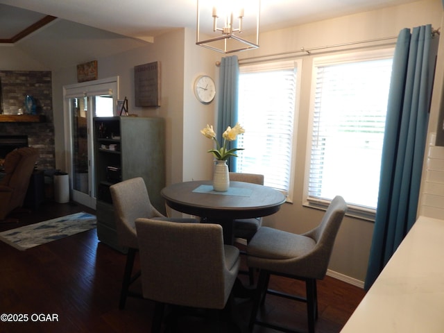 2722 E Wickersham Rd, Joplin, MO 64804 - dining space with a chandelier, dark wood-style flooring, a fireplace, and lofted ceiling