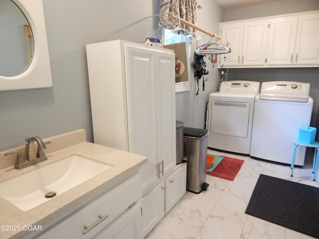 2722 E Wickersham Rd, Joplin, MO 64804 - washroom featuring washer and dryer, light marble finish floors, and cabinet space