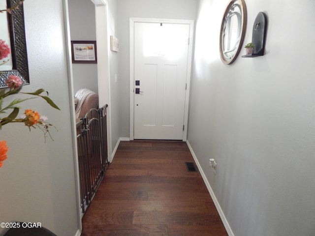 2722 E Wickersham Rd, Joplin, MO 64804 - doorway with dark wood-style floors and baseboards