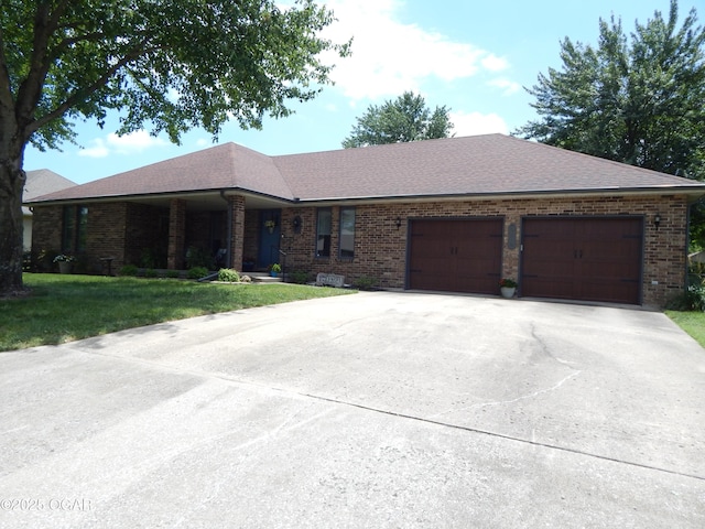 2722 E Wickersham Rd, Joplin, MO 64804 - ranch-style home featuring brick siding, an attached garage, and concrete driveway