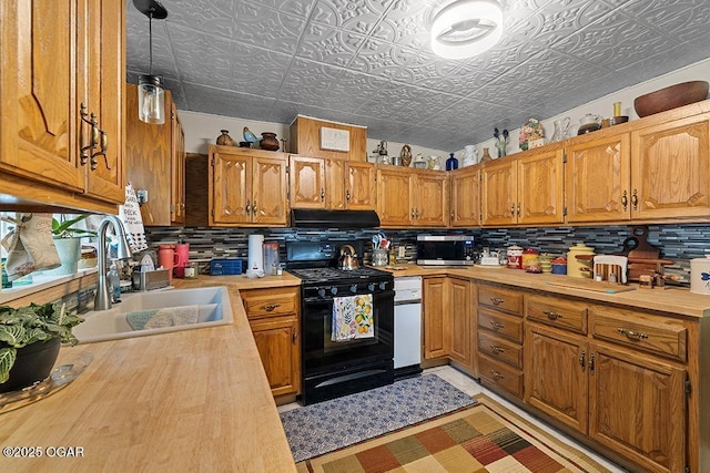 417 S Mcgregor St, Carthage, MO 64836 - kitchen with black gas range, an ornate ceiling, decorative backsplash, under cabinet range hood, and wooden counters