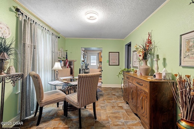 417 S Mcgregor St, Carthage, MO 64836 - dining space featuring stone finish flooring, a textured ceiling, and ornamental molding