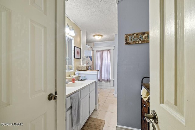 417 S Mcgregor St, Carthage, MO 64836 - bathroom with a textured ceiling, vanity, and tile patterned flooring