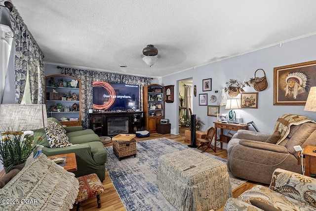 417 S Mcgregor St, Carthage, MO 64836 - living room featuring ornamental molding, a textured ceiling, wood finished floors, and a ceiling fan