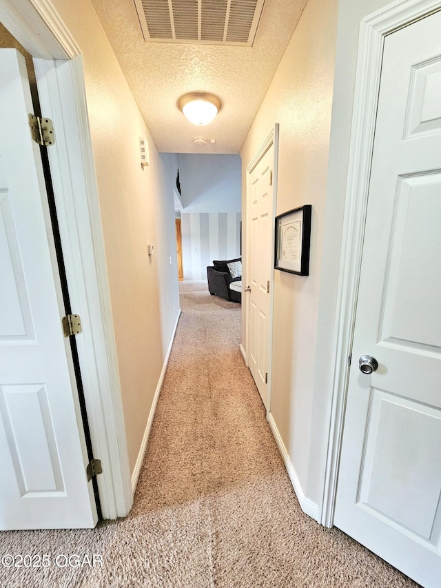 2813 Heartland Ave, Joplin, MO 64804 - hallway featuring light carpet and a textured ceiling