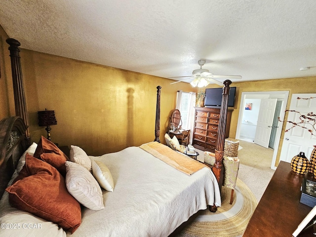 2813 Heartland Ave, Joplin, MO 64804 - bedroom featuring a wood stove, a textured ceiling, carpet floors, and ceiling fan