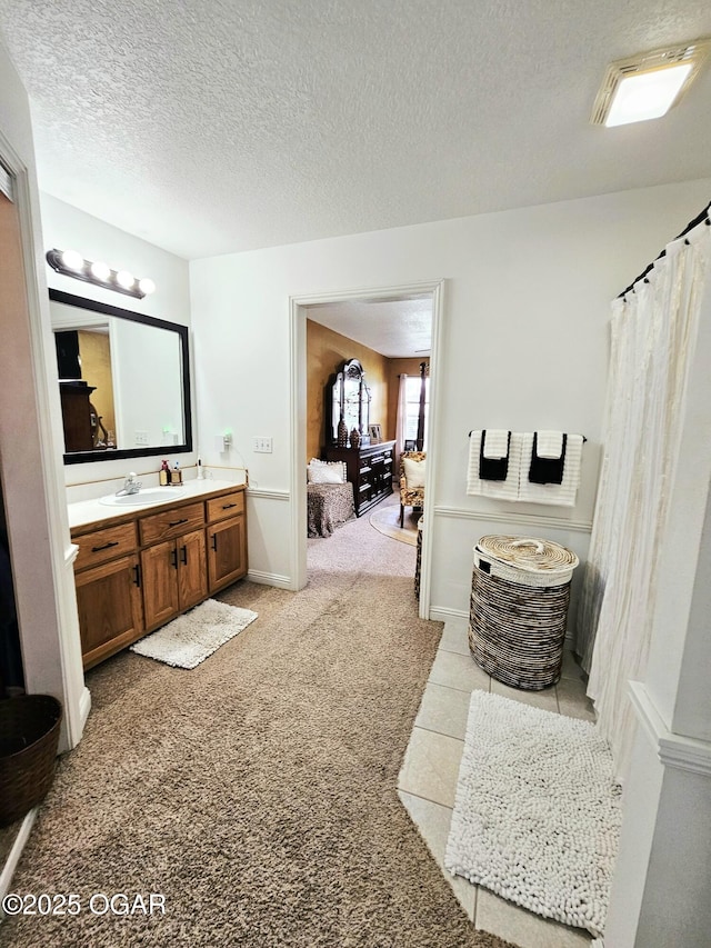 2813 Heartland Ave, Joplin, MO 64804 - ensuite bathroom with vanity, a textured ceiling, and carpet