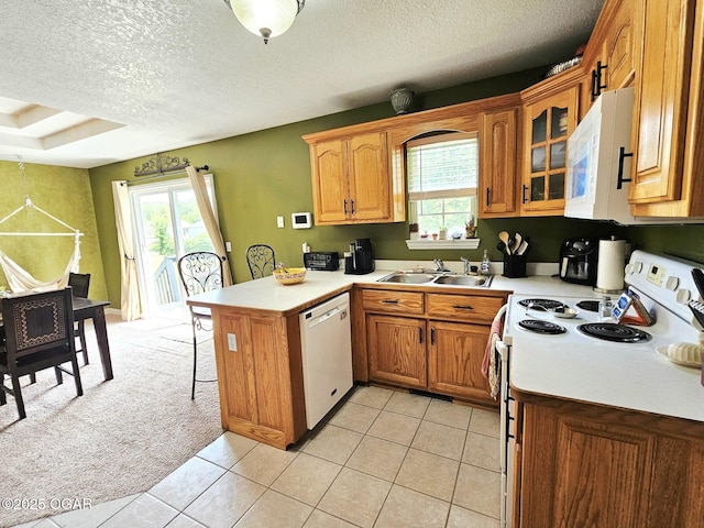 2813 Heartland Ave, Joplin, MO 64804 - kitchen with white appliances, a peninsula, a kitchen breakfast bar, healthy amount of natural light, and a textured ceiling