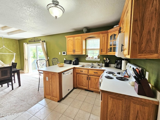 2813 Heartland Ave, Joplin, MO 64804 - kitchen with white appliances, a peninsula, a textured ceiling, a breakfast bar, and light countertops
