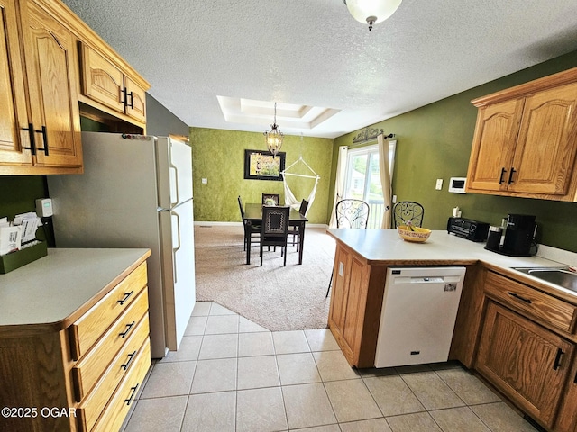 2813 Heartland Ave, Joplin, MO 64804 - kitchen featuring white appliances, light carpet, a textured ceiling, a peninsula, and light countertops