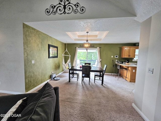 2813 Heartland Ave, Joplin, MO 64804 - dining area featuring a tray ceiling, light colored carpet, and a textured ceiling