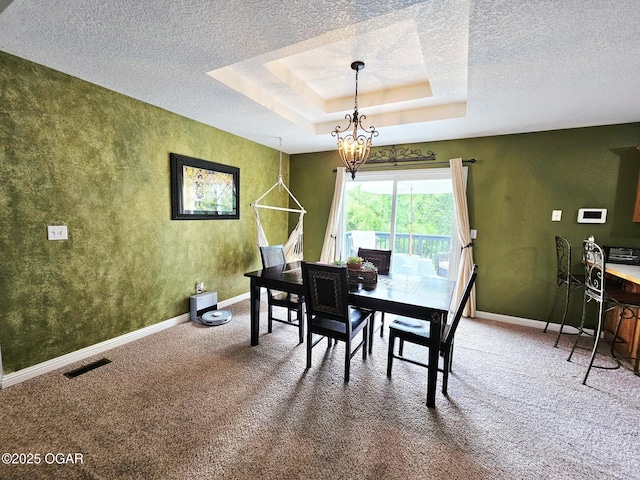 2813 Heartland Ave, Joplin, MO 64804 - carpeted dining room with a textured ceiling, a tray ceiling, and a chandelier