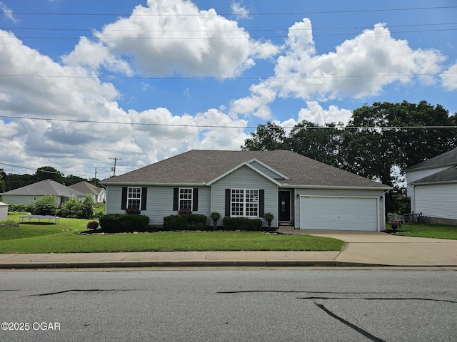 2813 Heartland Ave, Joplin, MO 64804 - ranch-style house featuring concrete driveway, a garage, a front lawn, and roof with shingles