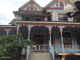 729 W Central Ave, Carthage, MO 64836 - victorian house with a porch