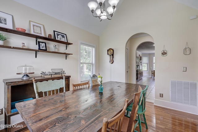 3510 Notting Hill Cir, Joplin, MO 64804 - dining space with arched walkways, plenty of natural light, a chandelier, lofted ceiling, and wood finished floors