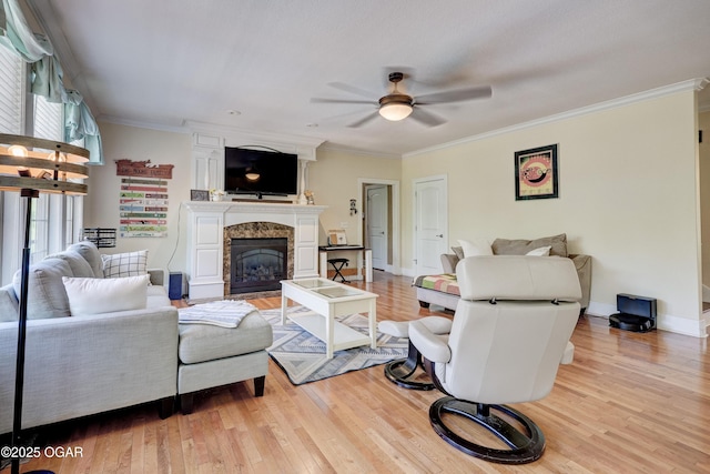 3510 Notting Hill Cir, Joplin, MO 64804 - living room featuring a ceiling fan, light wood finished floors, a premium fireplace, and crown molding