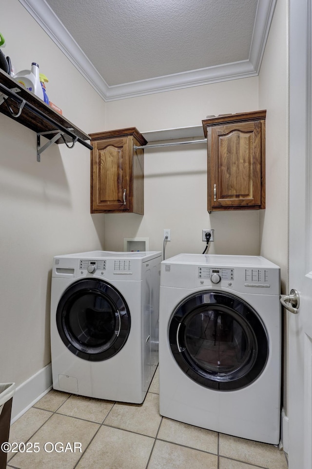 3510 Notting Hill Cir, Joplin, MO 64804 - washroom with crown molding, washer and clothes dryer, cabinet space, light tile patterned floors, and a textured ceiling