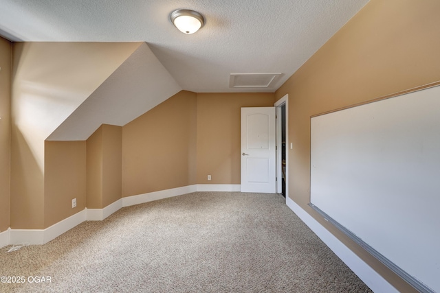 3510 Notting Hill Cir, Joplin, MO 64804 - additional living space with carpet floors, a textured ceiling, attic access, and lofted ceiling