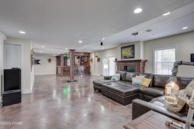 3510 Notting Hill Cir, Joplin, MO 64804 - living area featuring a textured ceiling, recessed lighting, and a fireplace