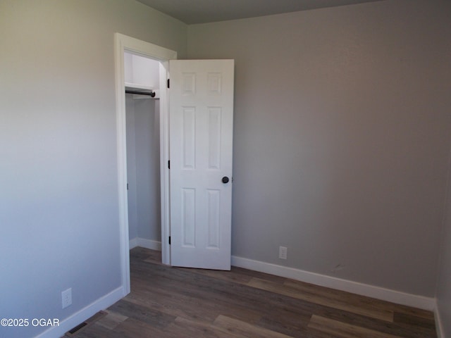 2705 S Michigan Ave, Joplin, MO 64804 - unfurnished bedroom with dark wood-style flooring and a closet