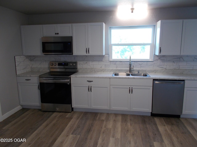 2705 S Michigan Ave, Joplin, MO 64804 - kitchen with dishwasher, stainless steel range with electric cooktop, white cabinetry, decorative backsplash, and light countertops