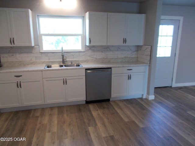 2705 S Michigan Ave, Joplin, MO 64804 - kitchen featuring stainless steel dishwasher, white cabinets, tasteful backsplash, and light countertops