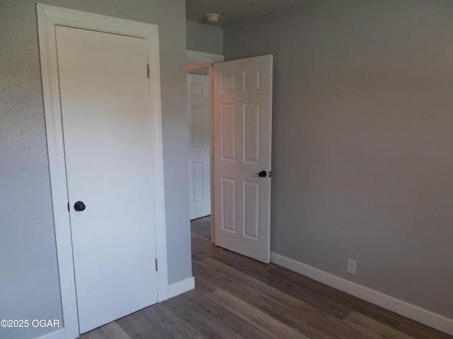 2705 S Michigan Ave, Joplin, MO 64804 - unfurnished bedroom with dark wood-style flooring