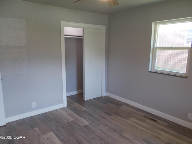 2705 S Michigan Ave, Joplin, MO 64804 - unfurnished bedroom with wood finished floors, a closet, and a ceiling fan