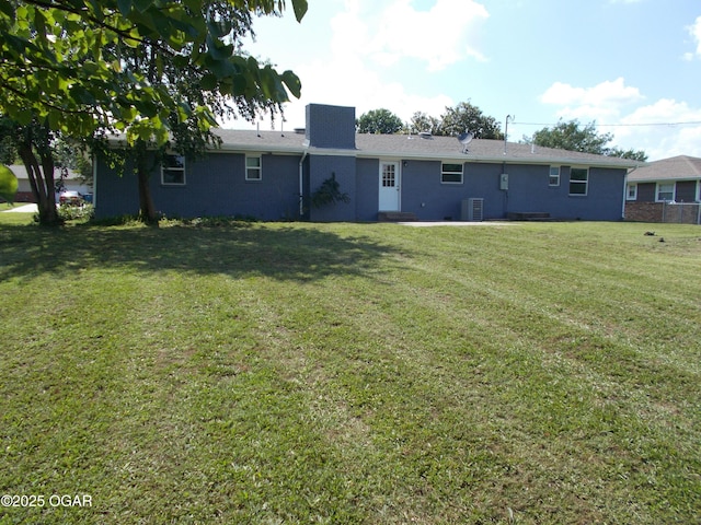 2705 S Michigan Ave, Joplin, MO 64804 - back of property featuring a chimney, a lawn, and brick siding
