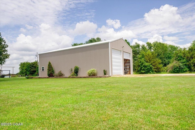 11284 Norway Rd, Neosho, MO 64850 - view of home's exterior with a detached garage, a lawn, and an outbuilding