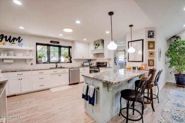 11284 Norway Rd, Neosho, MO 64850 - kitchen featuring stainless steel appliances, light wood-style floors, light stone countertops, tasteful backsplash, and recessed lighting