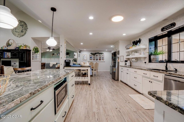 11284 Norway Rd, Neosho, MO 64850 - kitchen with appliances with stainless steel finishes, light wood-style floors, stone countertops, white cabinetry, and decorative light fixtures