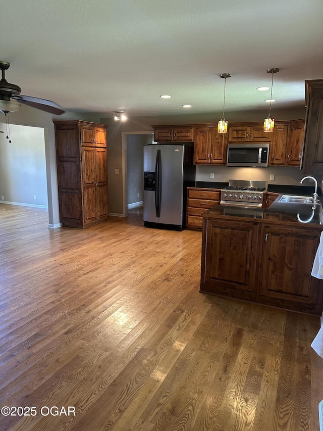 2223 Texas Ave, Joplin, MO 64804 - kitchen with appliances with stainless steel finishes, dark countertops, ceiling fan, light wood-style flooring, and recessed lighting