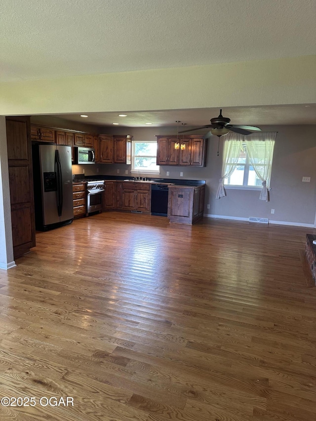 2223 Texas Ave, Joplin, MO 64804 - kitchen with stainless steel appliances, wood finished floors, and dark countertops