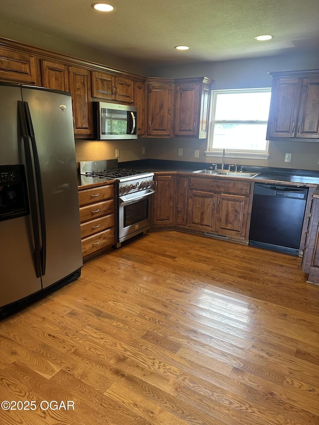 2223 Texas Ave, Joplin, MO 64804 - kitchen with stainless steel appliances, light wood-style floors, dark countertops, and recessed lighting