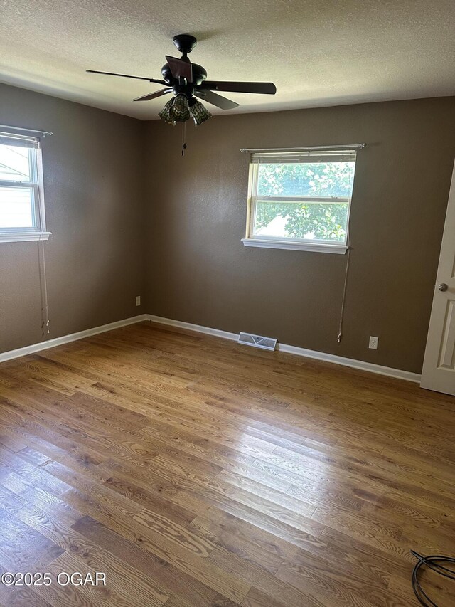 2223 Texas Ave, Joplin, MO 64804 - spare room with wood finished floors, ceiling fan, and a textured ceiling