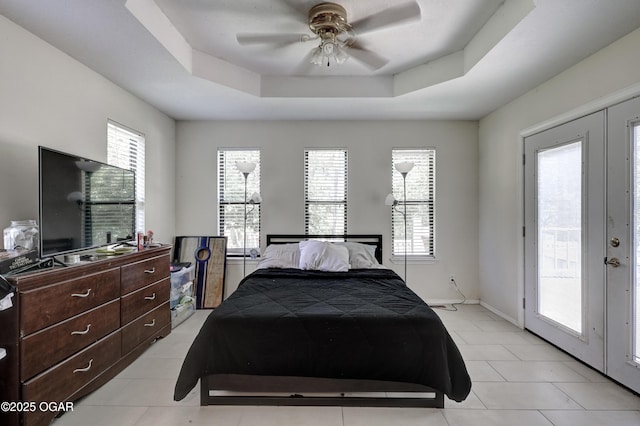 5223 County Lane 301, Joplin, MO 64801 - bedroom with access to exterior, multiple windows, a raised ceiling, and light tile patterned floors